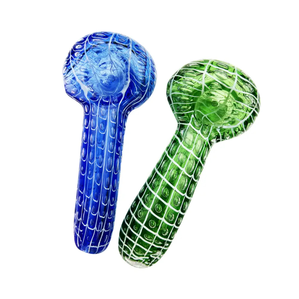 Two spoon-shaped glass hand pipes, one vibrant blue and one bright green, both featuring a bubble trap and netted pattern design, displayed against a white background.