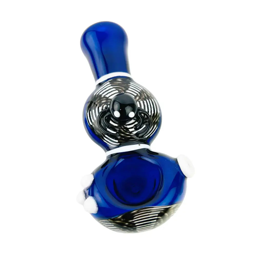 A vibrant blue glass hand pipe with a black and white swirling spider web design and a small black spider embellishment on the bowl, presented against a white background.