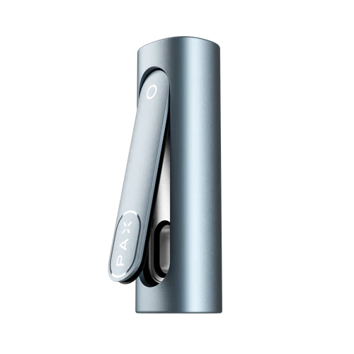 Close-up, slightly angled view of a metallic blue portable dry herb vaporizer, showing the hinged lid with 'PAX' logo and a circular light indicator.