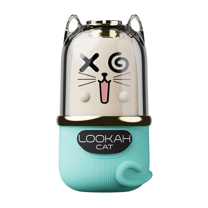 Front view of a cat-themed 510 cartridge battery, featuring a light blue silicone base with a curled tail-like grip and a clear top revealing a cream-colored cat face with a winking eye and open mouth.