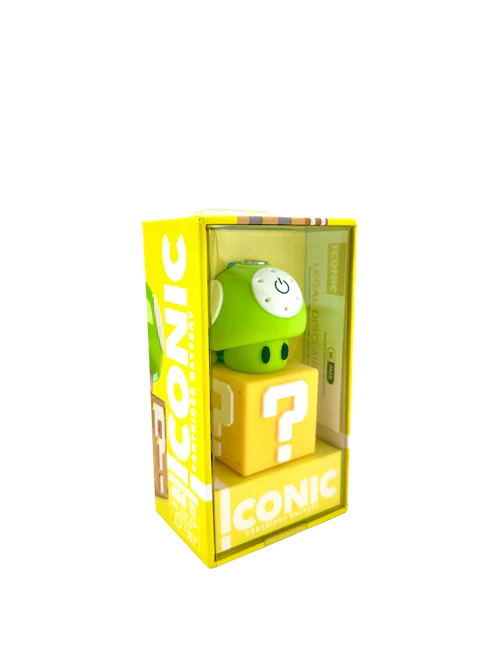 A green mushroom-style 510 cartridge vaporizer battery is displayed inside its yellow and clear plastic packaging, featuring 'ICONIC' branding and a yellow question mark block base, viewed from a slightly elevated angle.