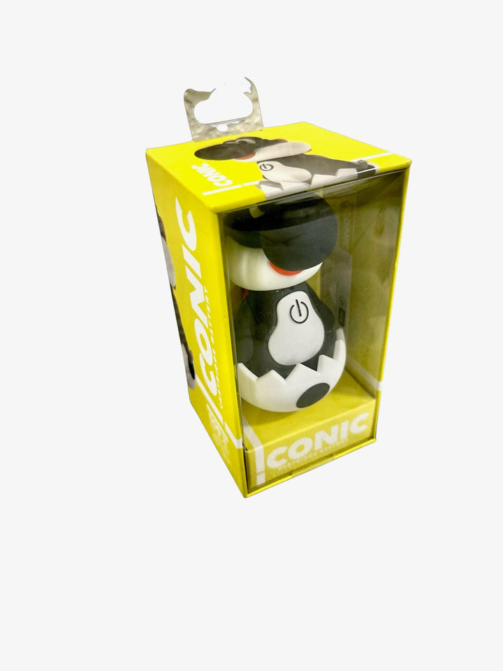Close-up of a yellow retail box containing a black and white dinosaur-like vaporizer battery in a cracked egg, with 'ICONIC' branding.