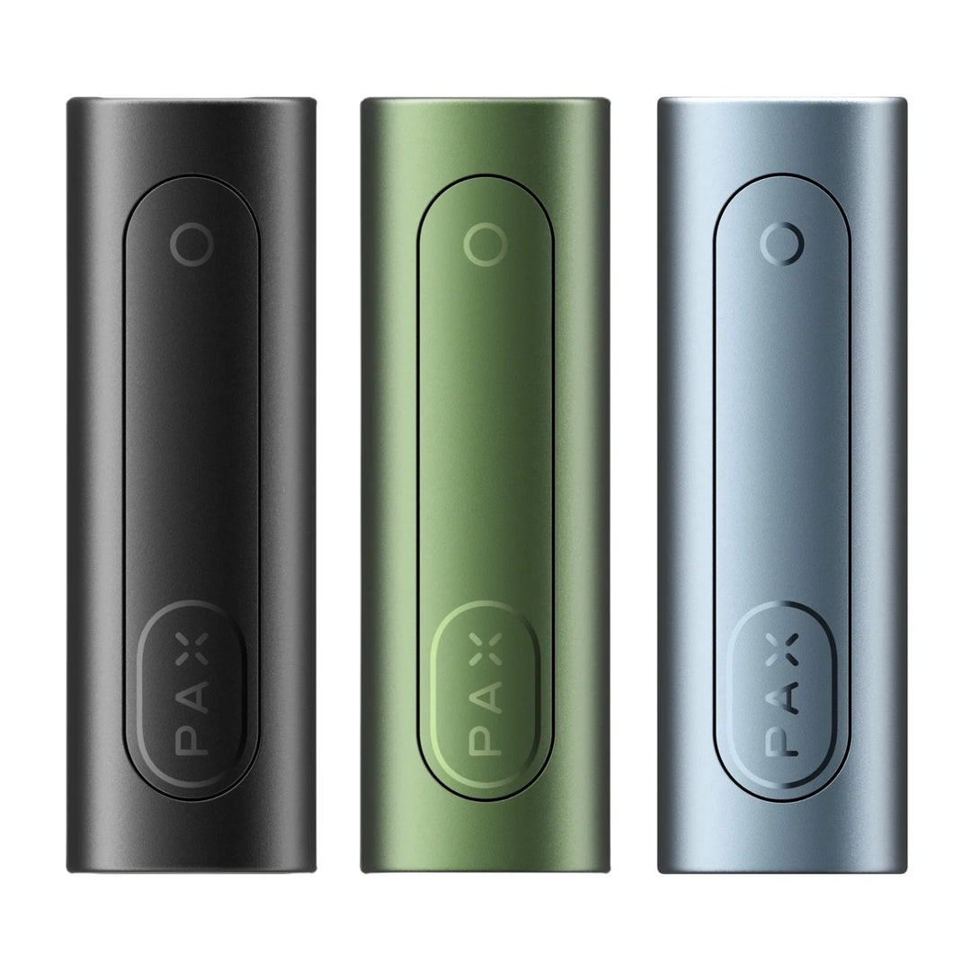 Three sleek, rectangular portable vaporizers standing upright, one in black, one in olive green, and one in light blue, each with a circular button and 'PAX' logo.