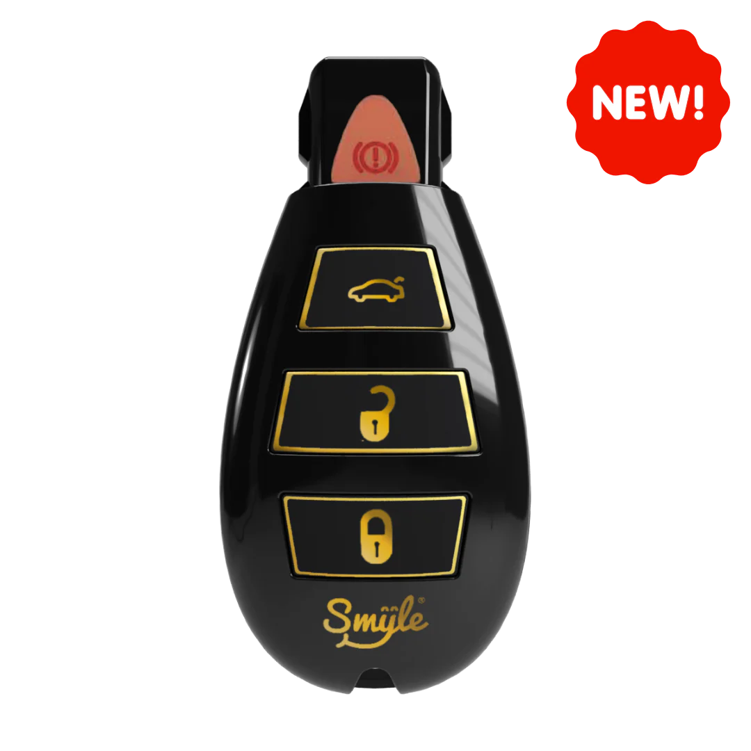 Close-up of a black car key fob-shaped vape battery with gold buttons and a gold 'Smiile' logo, featuring a red 'NEW!' sticker in the top right corner.