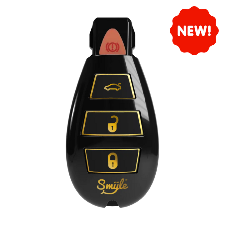 Close-up of a black car key fob-shaped vape battery with gold buttons and a gold 'Smiile' logo, featuring a red 'NEW!' sticker in the top right corner.