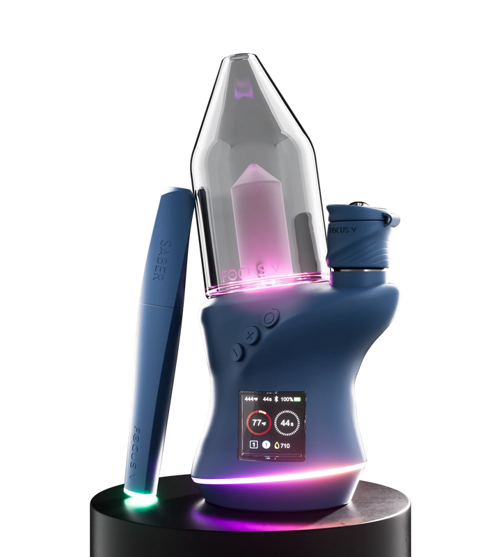 Close-up detail of a silver metal dabber tool, showing its curved scoop end and part of the ribbed handle against a white background.