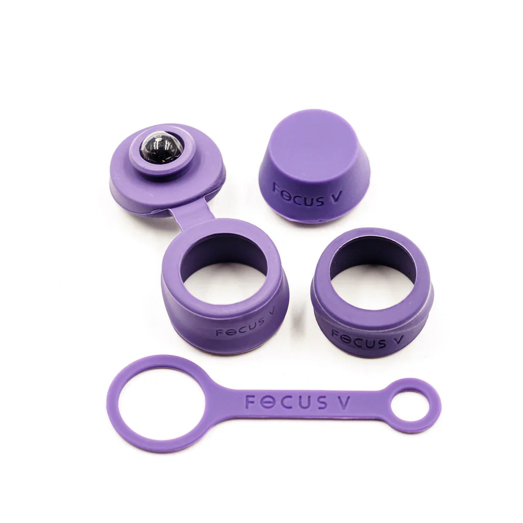 A set of purple silicone accessories for the Focus V CARTA 2, including various caps, rings, and a flat tool, displayed against a white background.