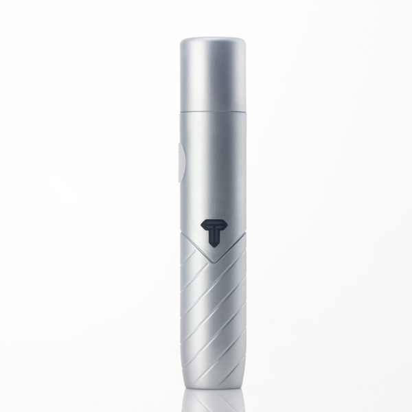 Close-up, front-facing studio shot of a sleek, silver, cylindrical device with a black 'T' logo and diagonal textured grooves on the lower body, standing upright.