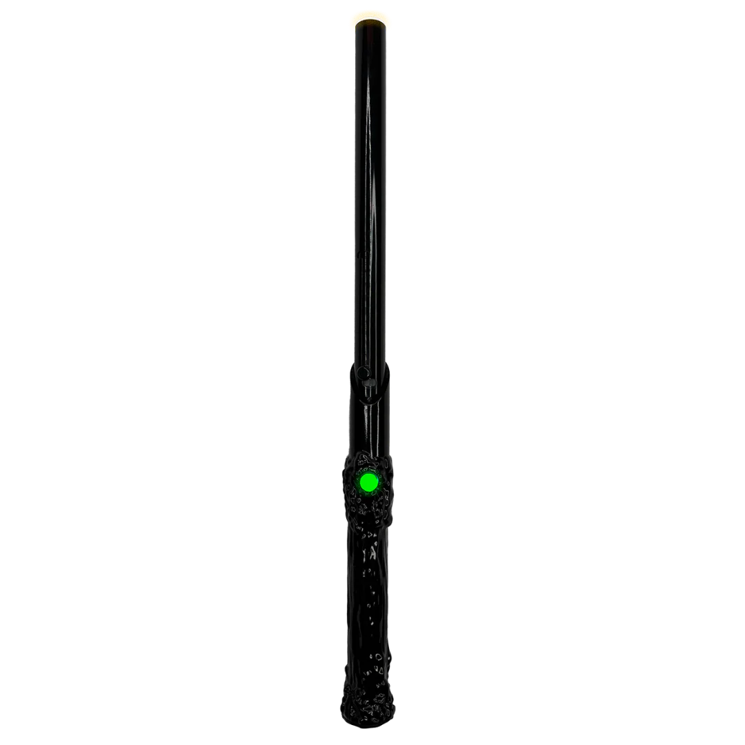 A sleek black wand-shaped 510 vape battery with a glowing green button and a subtle yellow glow at its tip, presented vertically against a dark background.
