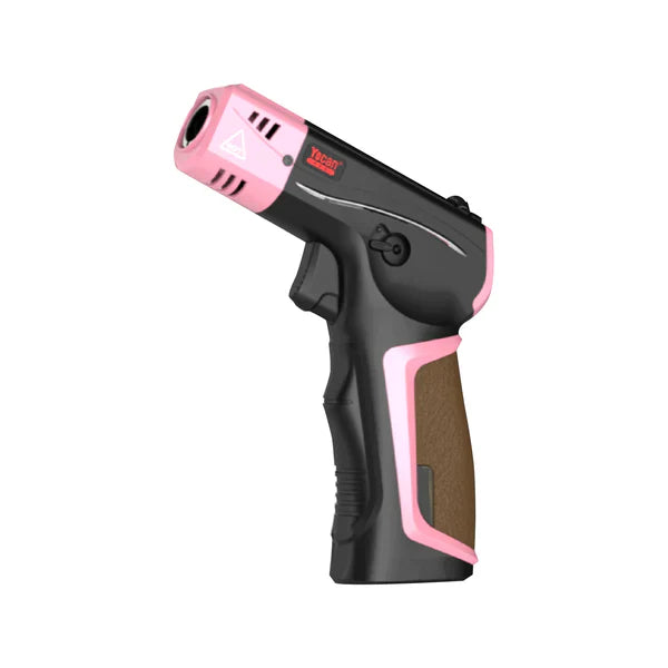 Close-up, angled view of a pink and black butane torch, highlighting the nozzle, trigger, and textured grip.