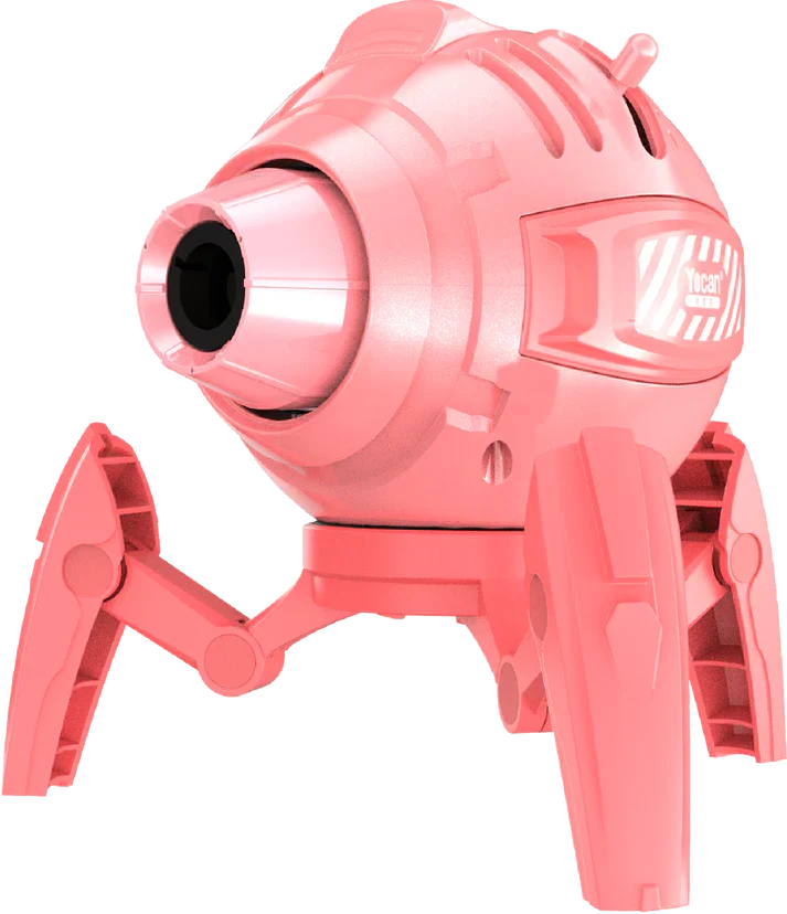 Close-up, angled view of a pink, spider-like butane torch with four articulated legs, showcasing its spherical body, nozzle, and 'Yocan Red' branding on the side.