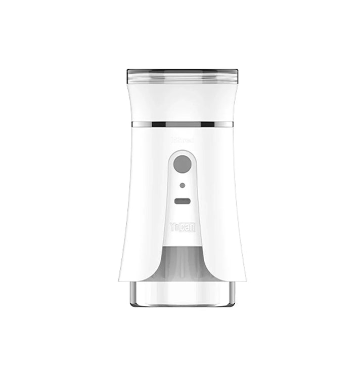 Front view of a white electric dry herb grinder with a clear bottom section and a clear top lid. It features a gray control button and small indicator lights on its front.
