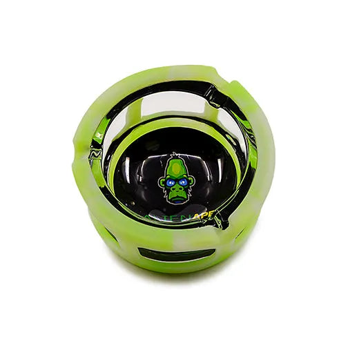 Top-down view of a round, bright green silicone-sleeved ashtray with a black glass interior featuring a green ape logo with blue glasses.