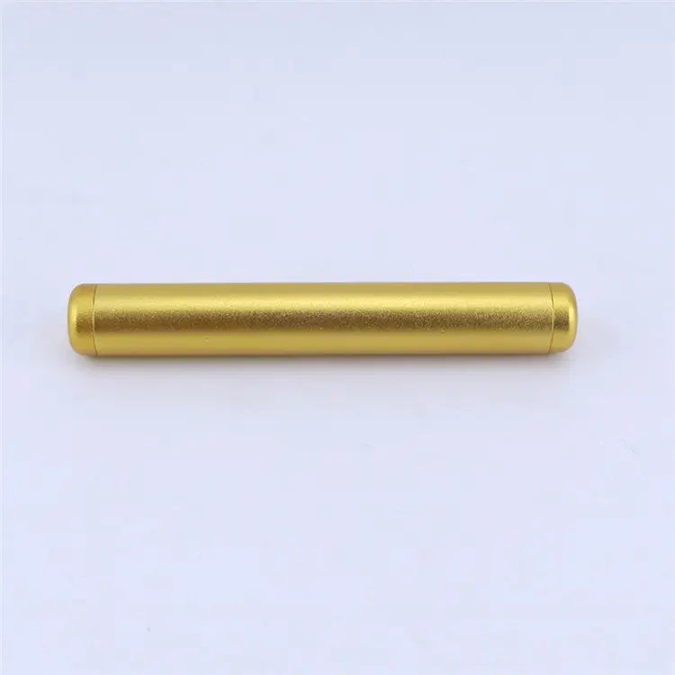 A straight-on, close-up shot of a single, sleek golden aluminum cylindrical tube, designed for odor-free travel storage, against a plain white background.