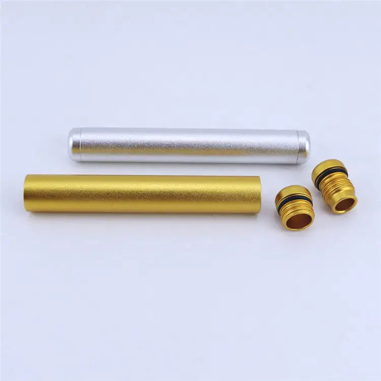 Two cylindrical aluminum tubes, one gold and one silver, are displayed horizontally on a white surface. Two small gold threaded caps with black O-rings are placed next to the gold tube, suggesting they are detachable parts.