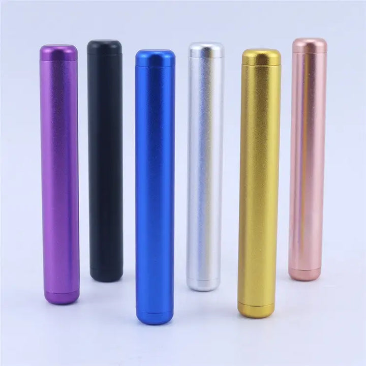 Six metallic cylindrical tubes in various colors including purple, black, blue, silver, gold, and rose gold, standing upright on a white surface, showcasing color options.