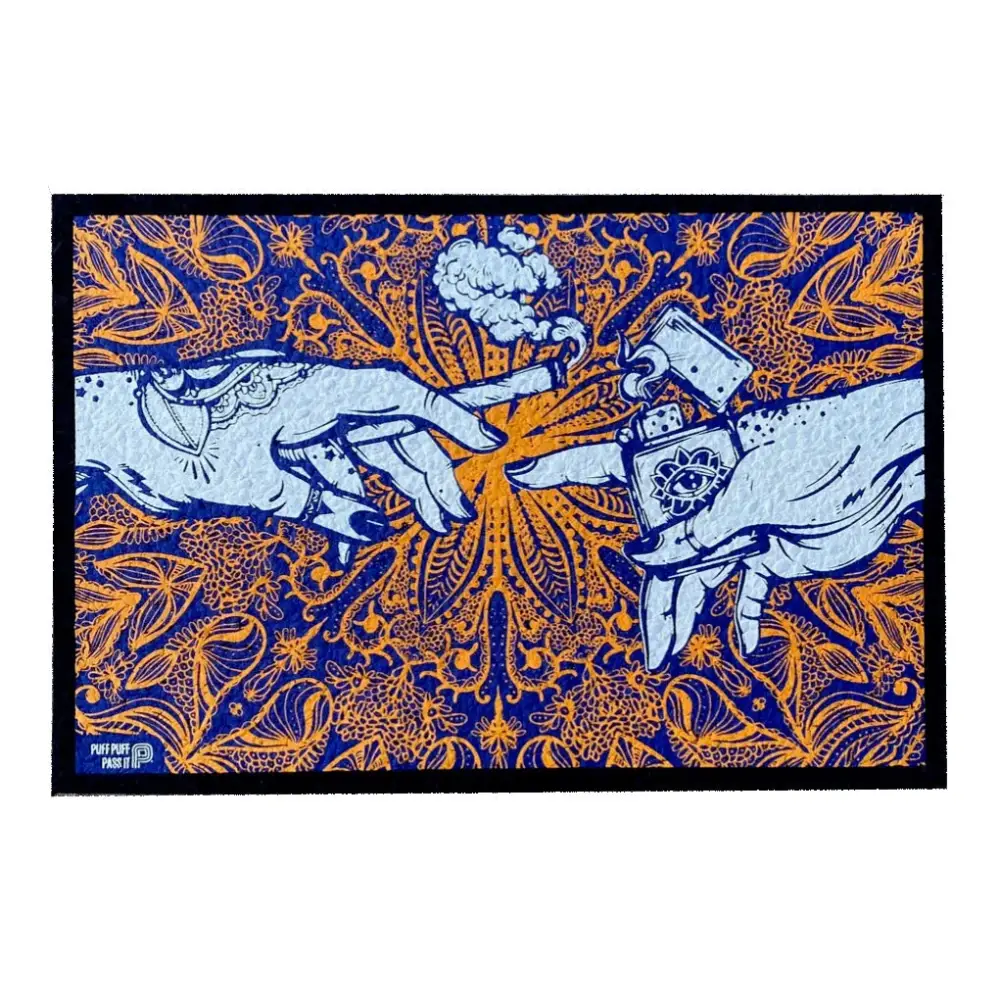 An art print or mat featuring two hands reaching towards each other, one holding a lit joint with smoke, the other holding a lighter with an all-seeing eye design, set against a vibrant orange mandala-like pattern on a dark blue background.
