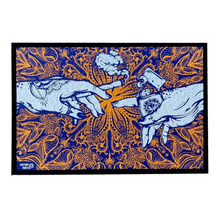 An art print or mat featuring two hands reaching towards each other, one holding a lit joint with smoke, the other holding a lighter with an all-seeing eye design, set against a vibrant orange mandala-like pattern on a dark blue background.