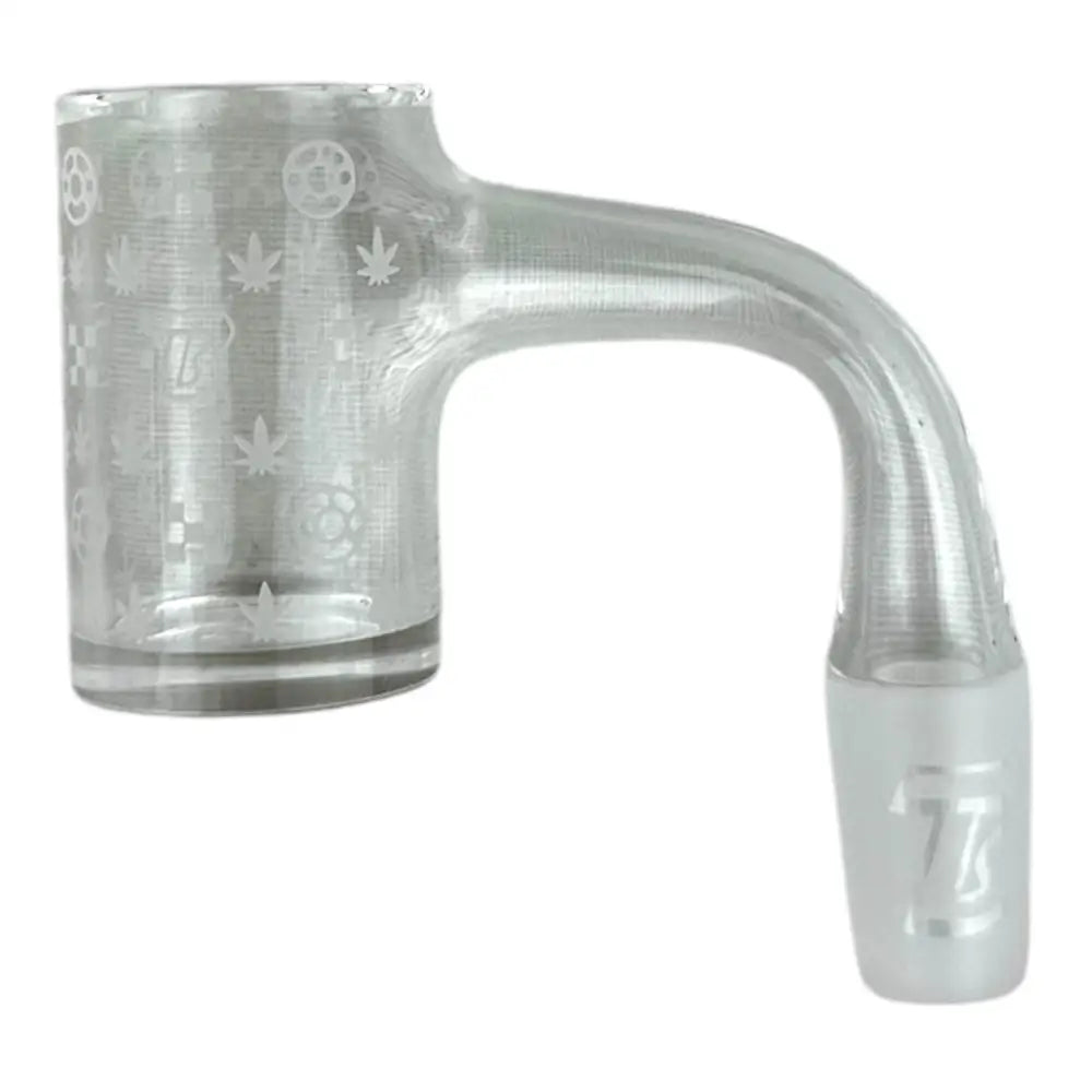 Close-up of a clear glass dab banger with a 90-degree neck and a frosted male joint. The bucket features etched patterns including cannabis leaves, gears, and a '77' logo.