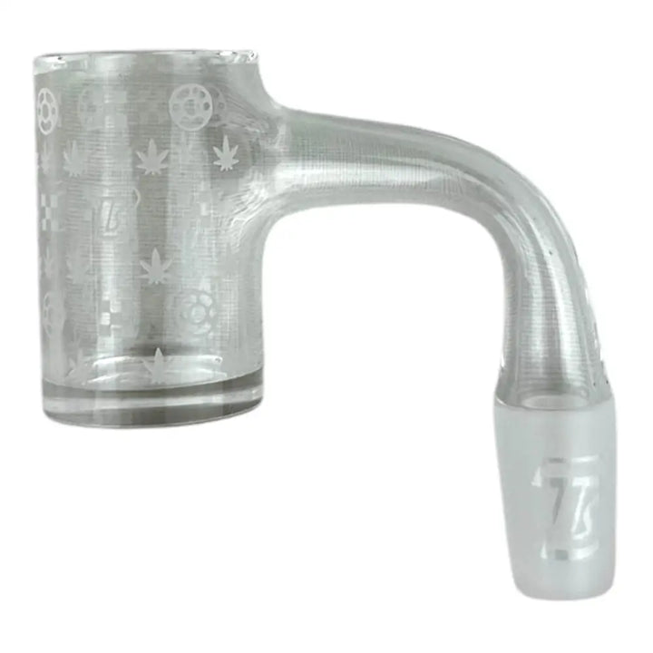 Close-up of a clear glass dab banger with a 90-degree neck and a frosted male joint. The bucket features etched patterns including cannabis leaves, gears, and a '77' logo.
