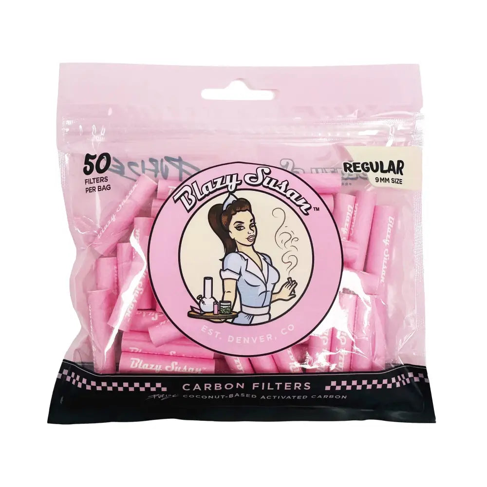 A clear plastic bag filled with numerous small pink cylindrical filters. The bag features a circular logo with a pin-up style woman and 'Blazy Susan' text, along with product details like '50 FILTERS PER BAG' and 'CARBON FILTERS'.