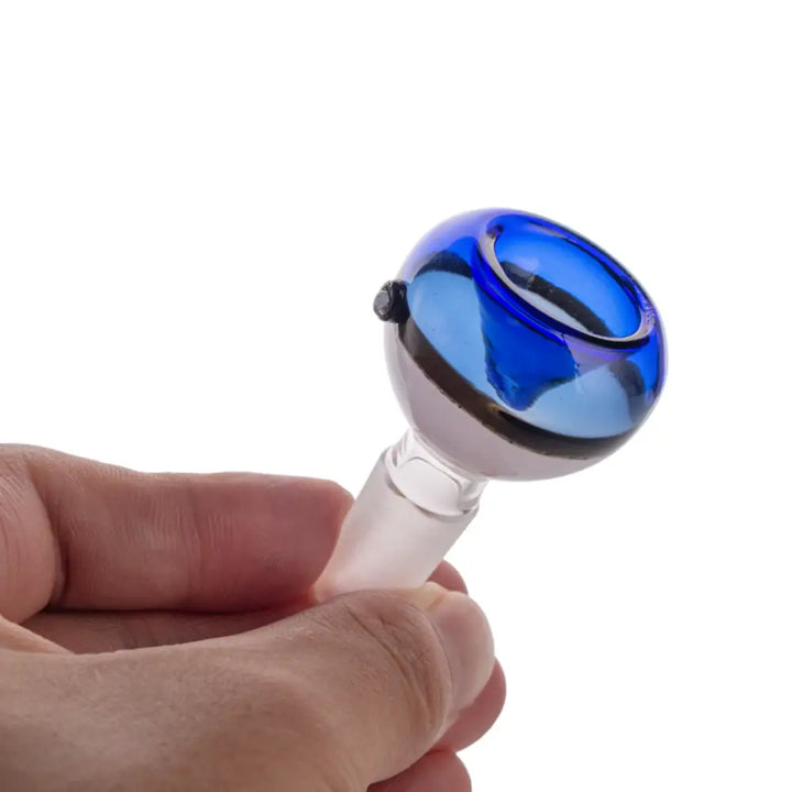 Close-up detail shot of a hand holding a blue and clear glass bowl piece, showcasing its spherical design and the clear joint.
