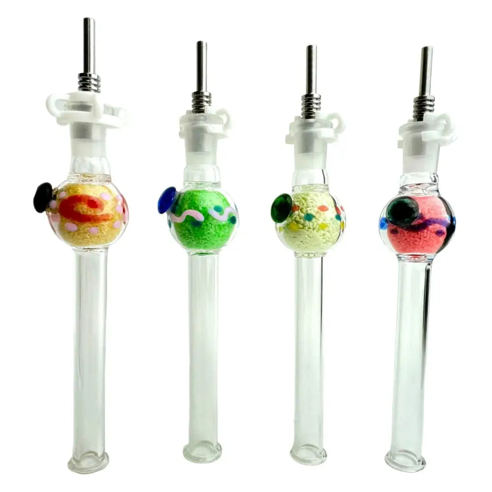 Four clear glass nectar collectors with titanium tips, each featuring a spherical chamber filled with different colored glow-in-the-dark speckled material and colored glass accents.
