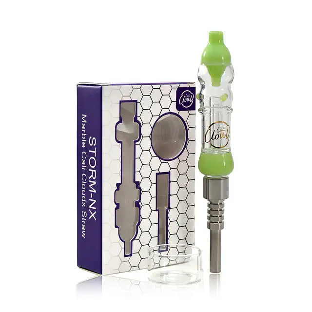 A green and clear glass nectar collector with a metal tip, displayed next to its purple and white packaging box featuring a honeycomb pattern. A small clear glass dish is also shown.