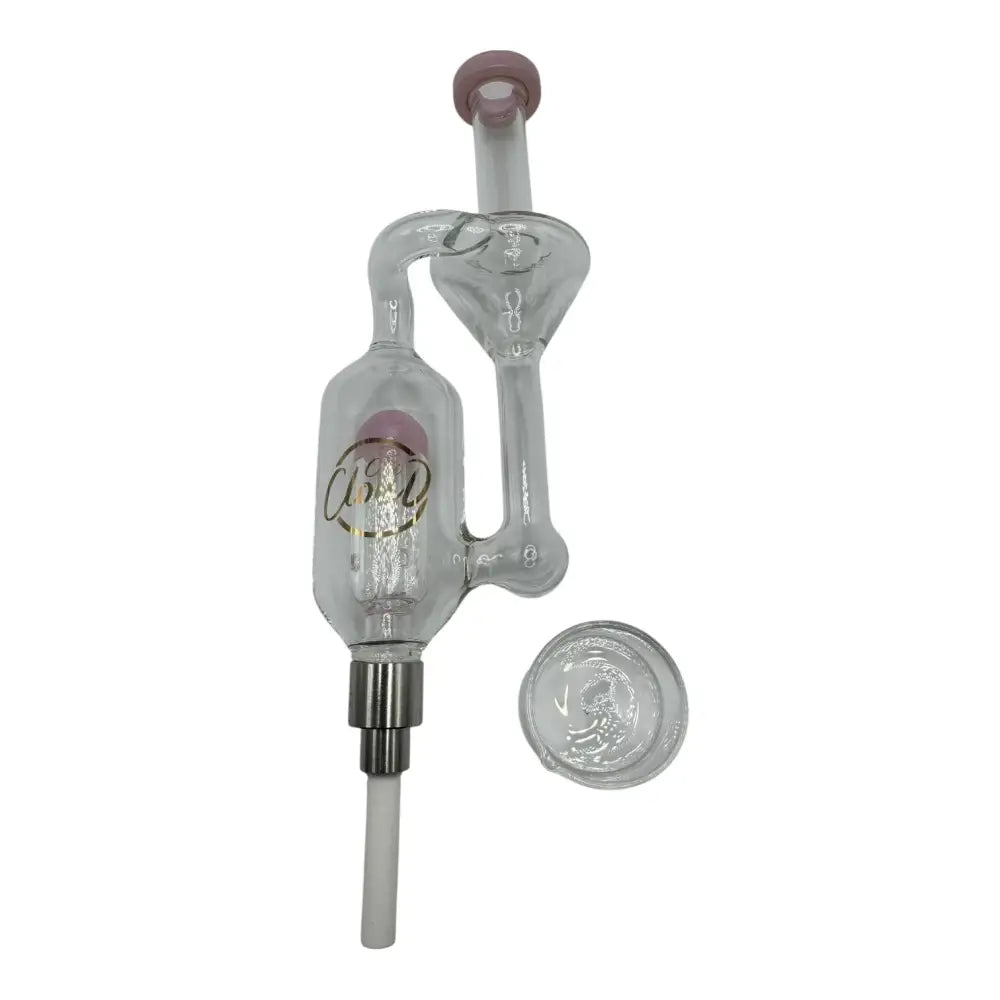 A clear glass mini nectar collector with a pink mouthpiece and a gold logo on the main chamber, shown with a separate glass dish.