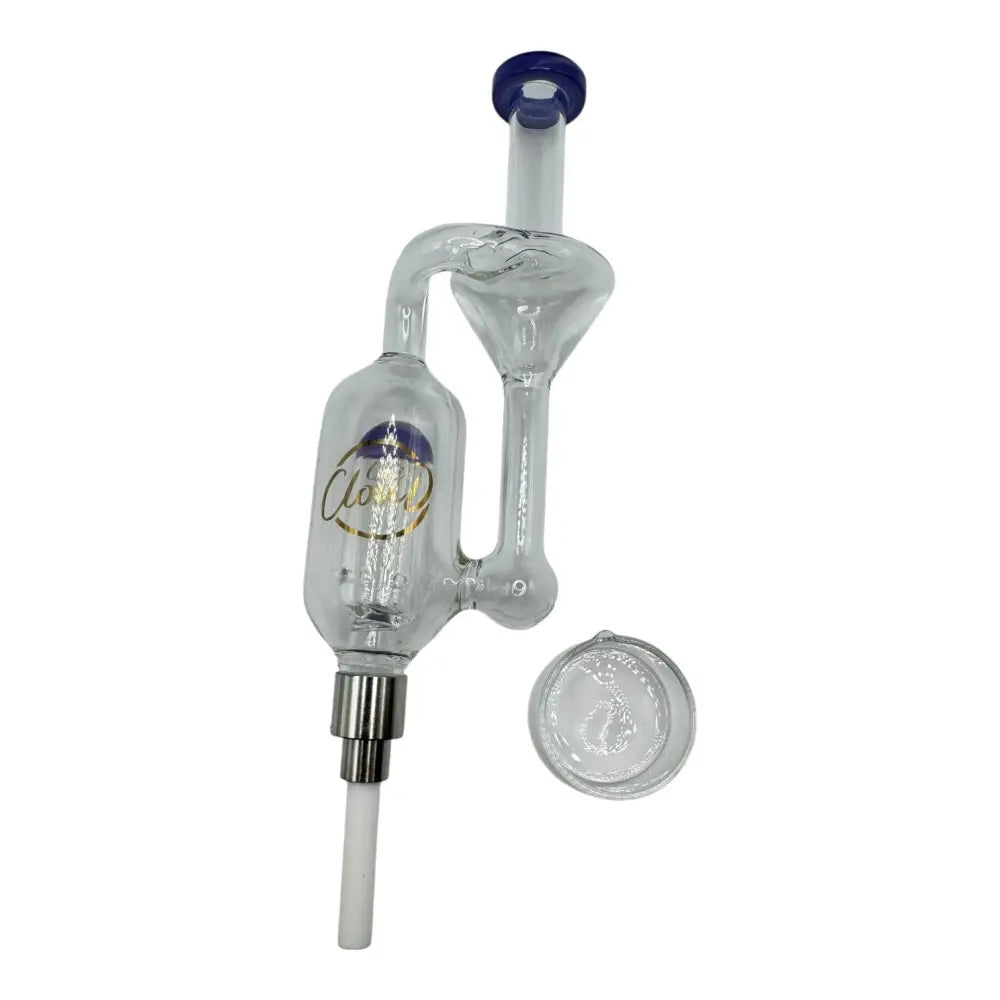 A clear glass mini nectar collector with a blue mouthpiece and a white ceramic tip, displayed alongside a small clear glass concentrate dish.