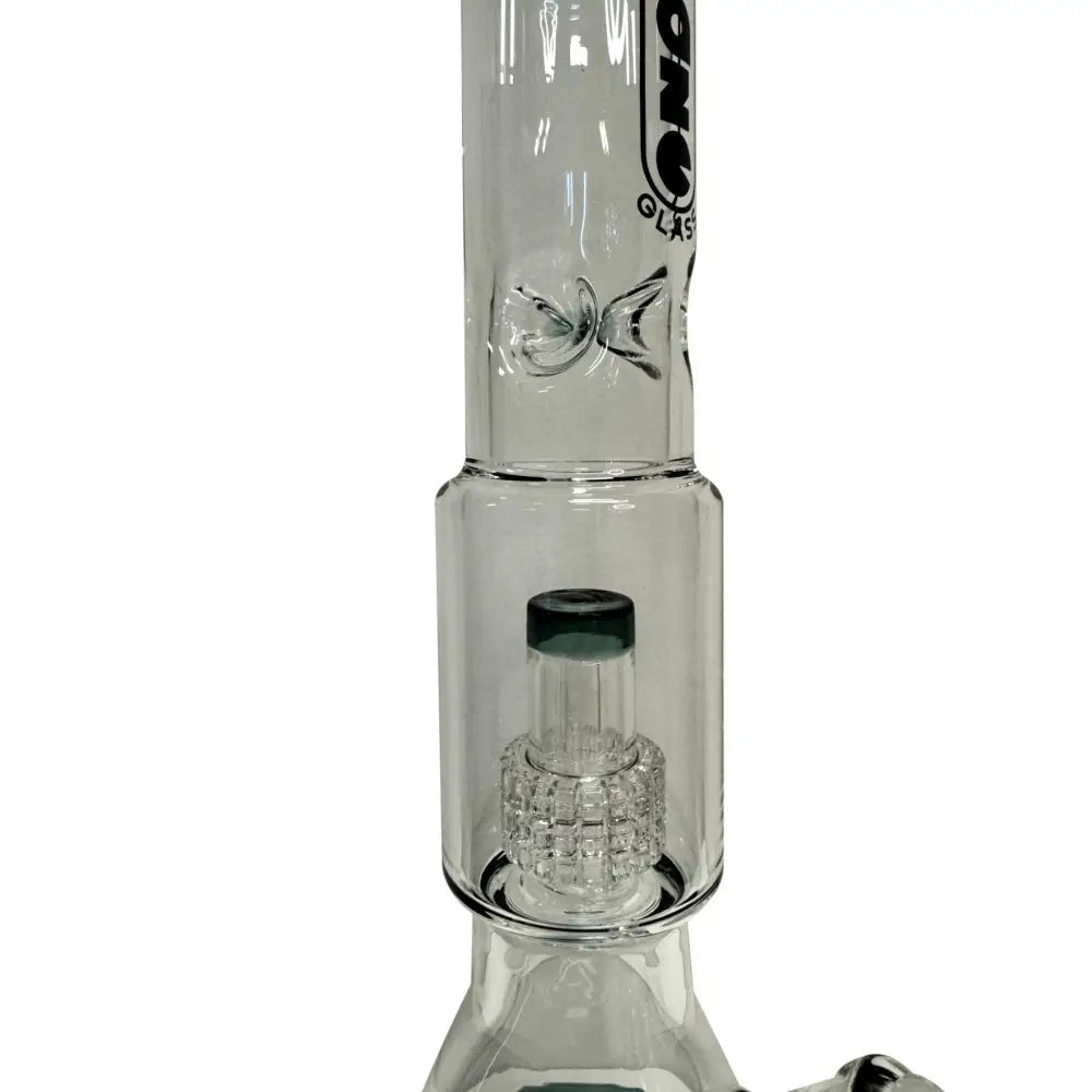Close-up detail shot of the middle section of a clear glass water pipe, showcasing the disc percolator with a dark green accent and the ice pinch above it.
