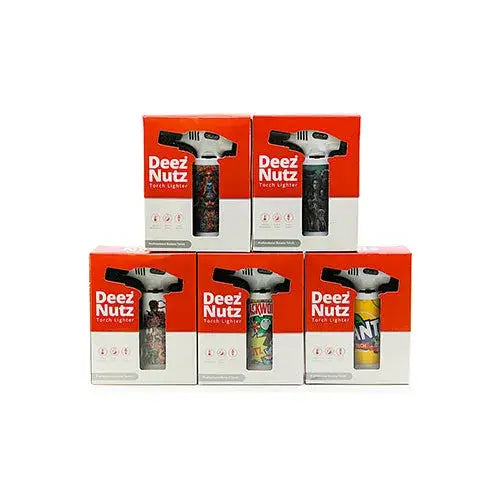 Five 'Deez Nutz' brand torch lighters in their individual orange and white retail packaging, arranged in two rows on a white background. Each lighter has a different graphic design.