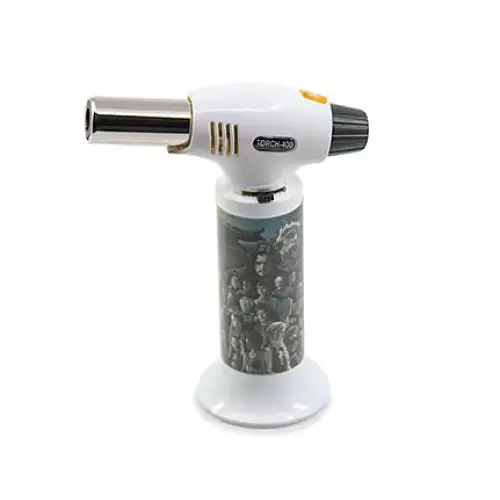 White and black torch lighter with a detailed graphic print of multiple figures on its cylindrical handle, standing upright on a white base.
