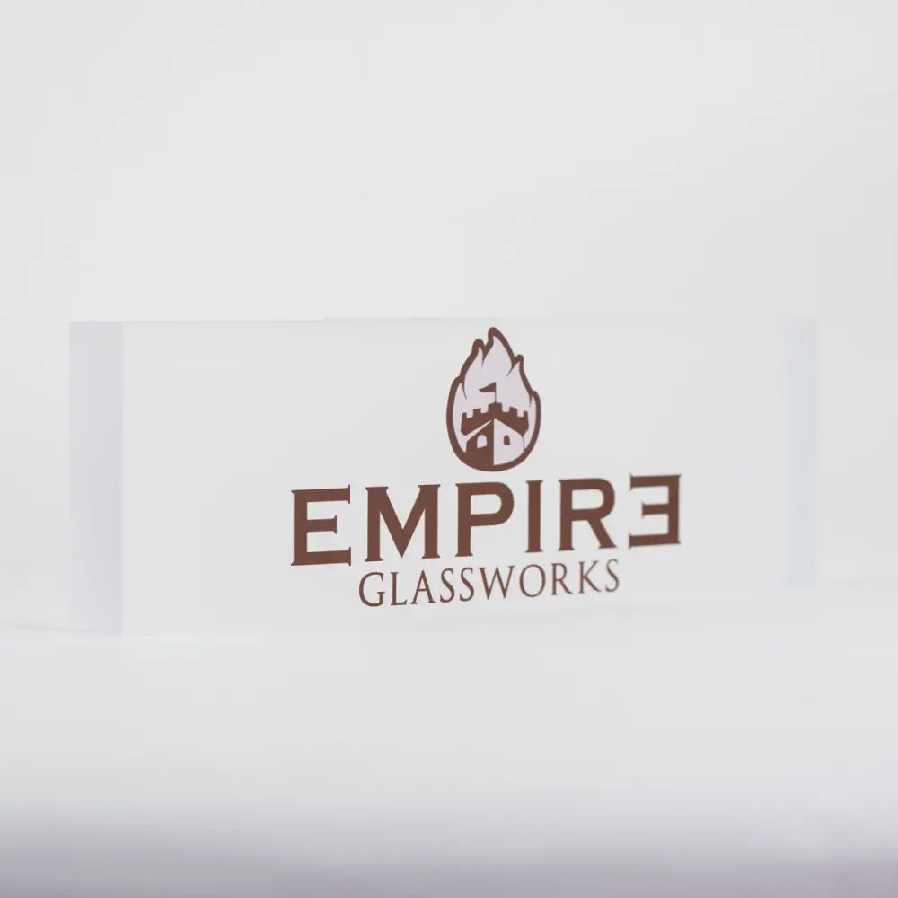 A clear rectangular acrylic plaque with the brown 'Empire Glassworks' logo, featuring a castle with flames, centered on a white background.