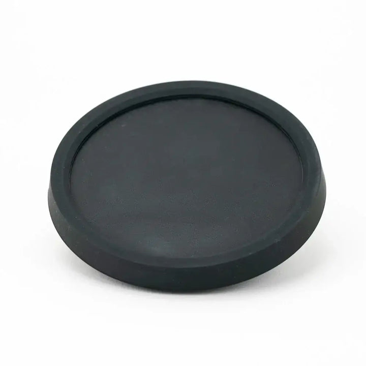 A black, circular, flat display stand with a slightly raised rim, shown from a slightly elevated angle against a clean white background.