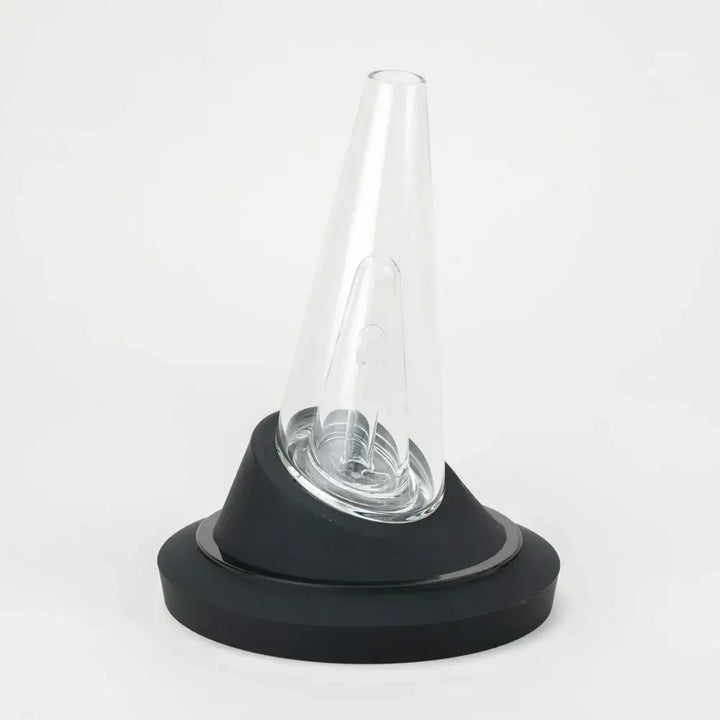 A black display stand with a clear, conical glass vaporizer attachment sitting upright on it, against a white background.