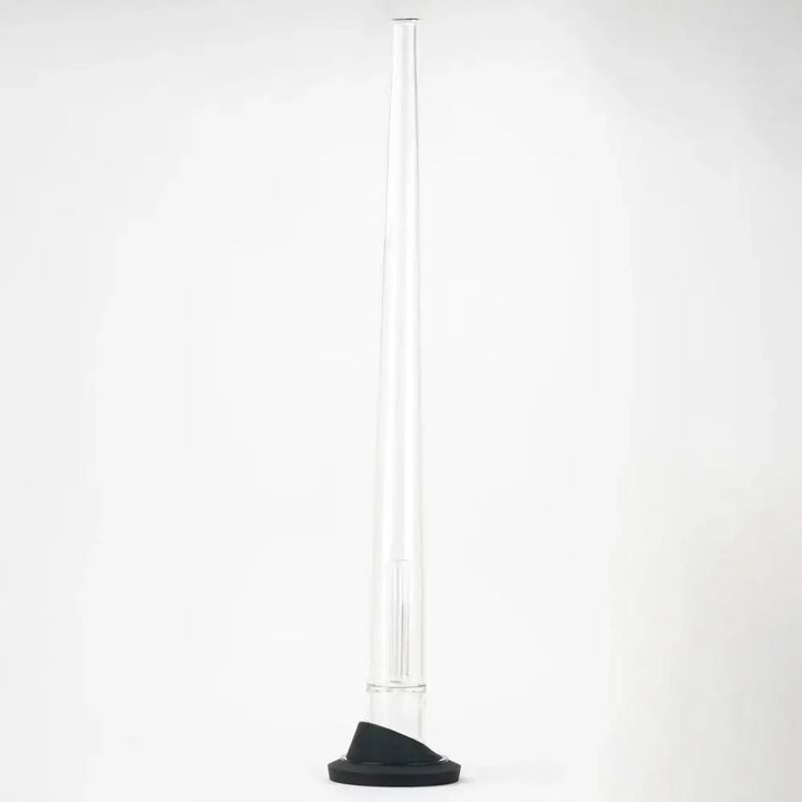 A tall, slender clear glass display stand with a black conical base, designed for a Peak attachment, shown upright against a white background.