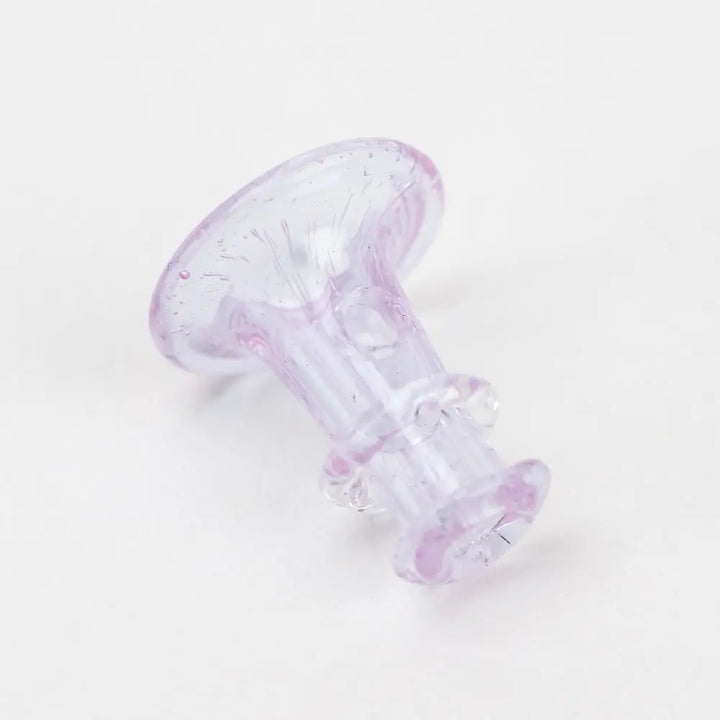 Close-up of a translucent pink glass joystick-shaped accessory, featuring a flared top and a cylindrical stem with two raised rings, against a white background.