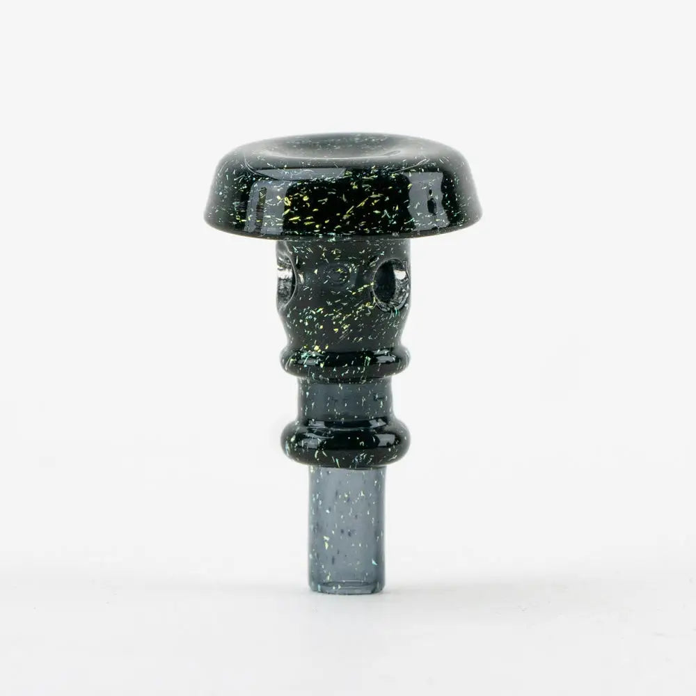 A dark, speckled glass accessory with a wide, flat top resembling a mushroom cap and a cylindrical stem with a narrow base.