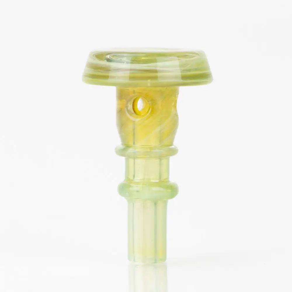 A translucent yellowish-green glass accessory with a flat, circular top, a cylindrical body featuring a small circular opening, and a ribbed stem, standing upright on a reflective surface.