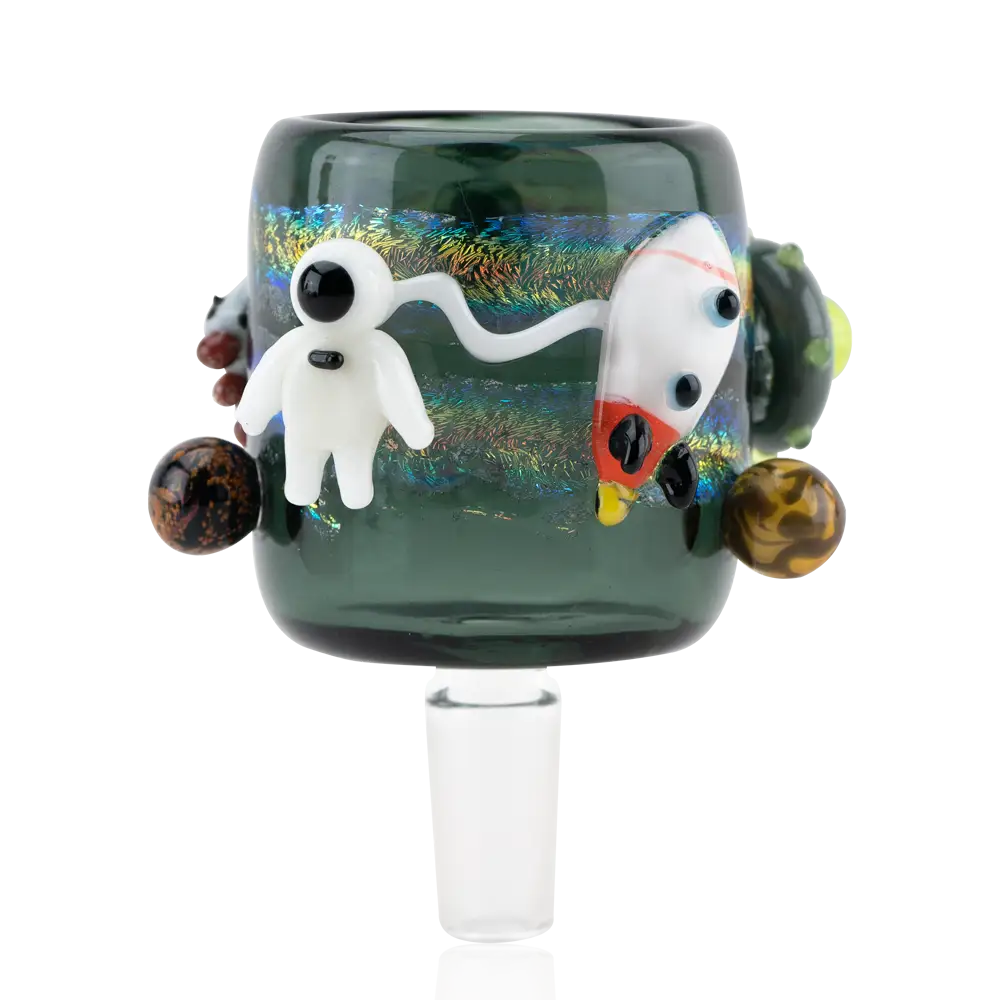 A dark green glass attachment featuring a white astronaut, a white and red rocket, and several small planet-like spheres, all set against an iridescent, starry background.
