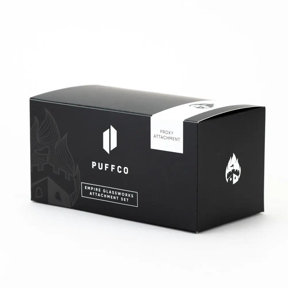 Black rectangular box packaging for a Puffco Proxy attachment set, featuring white text and logos, including a castle outline and a flame icon, set against a clean white background.