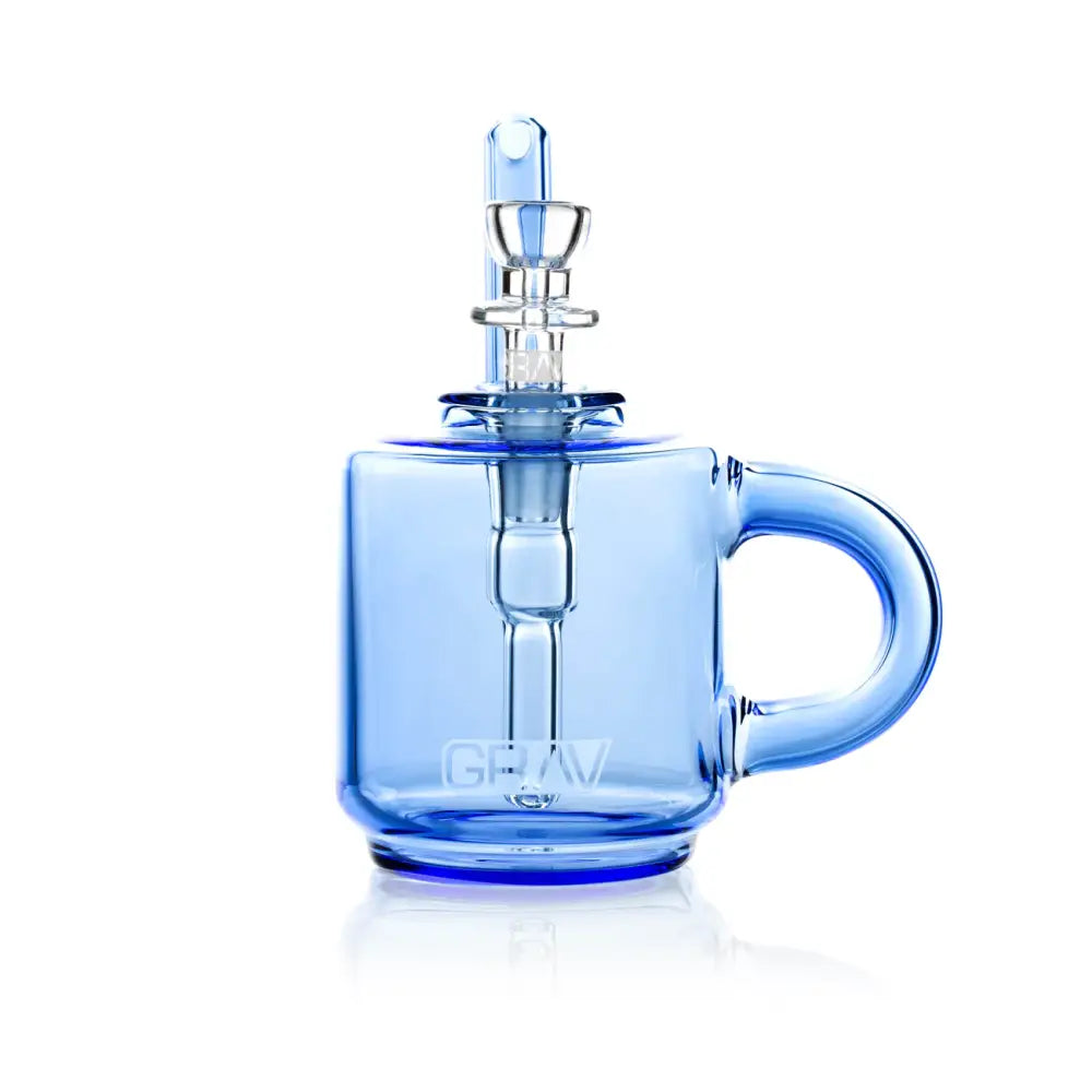 A blue glass bubbler designed like a coffee mug, featuring a clear glass bowl and mouthpiece, with the 'GRAV' logo visible on the side, presented against a clean white background.