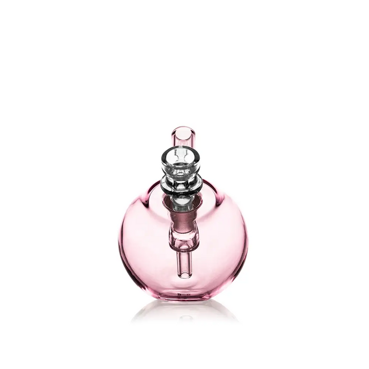 A compact, spherical pink glass bubbler with a clear glass mouthpiece and downstem, shown on a white background.