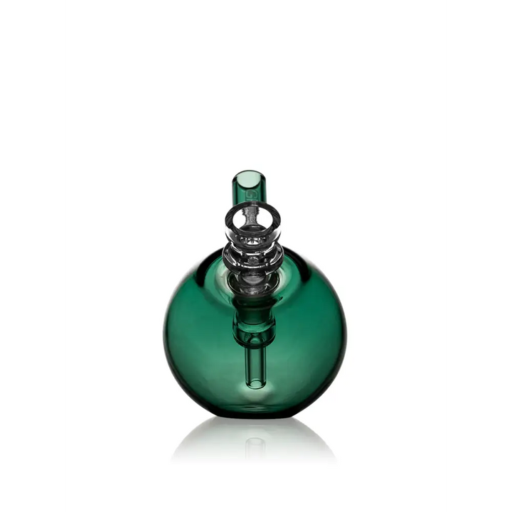 A compact, spherical green glass bubbler with a clear glass percolator and mouthpiece, presented on a reflective white background.