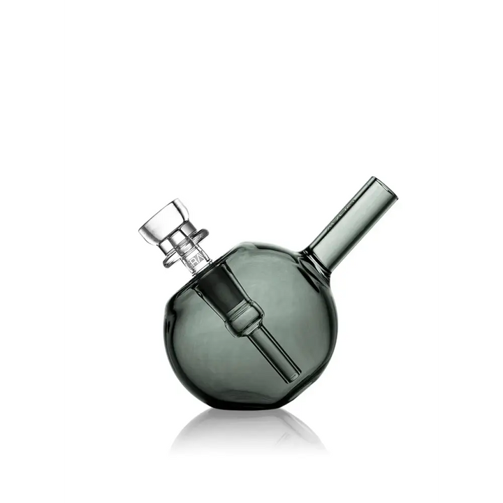 Compact, dark-tinted spherical glass bubbler with a clear glass bowl and angled mouthpiece, presented on a clean white background.