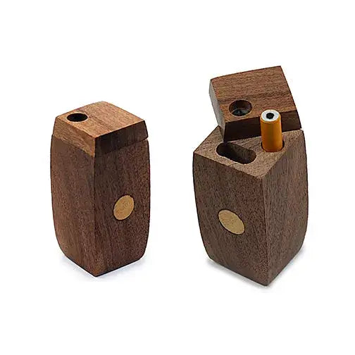 Two dark brown wooden dugouts on a white background. One is closed, and the other is open, revealing an orange one-hitter pipe inside.