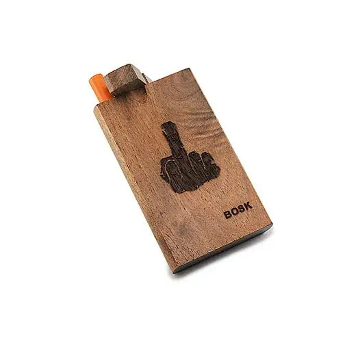 A rectangular wooden dugout box with an orange one-hitter pipe protruding from the top, featuring an engraved middle finger gesture and the word BOSK on its surface.