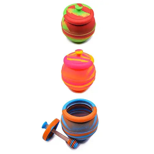 Three colorful silicone containers, each shaped like a honey pot with a lid. The top is red and green, the middle is orange and pink, and the bottom is blue and orange with a wooden honey dipper.