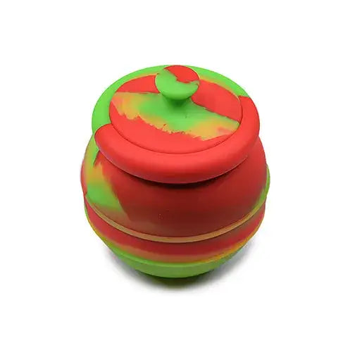 Close-up, slightly elevated view of a jumbo honey pot silicone container, featuring a vibrant red and green swirled pattern, with a matching lid.